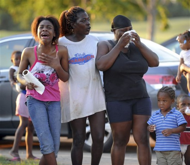 Family react as Shreveport Fire Department and Caddo Sheriff's deputies scour the beach at Charles and Marie Hamel Memorial Park in Shreveport, La. on Monday in search of teens believed to have drowned while swimming in the Red River. 